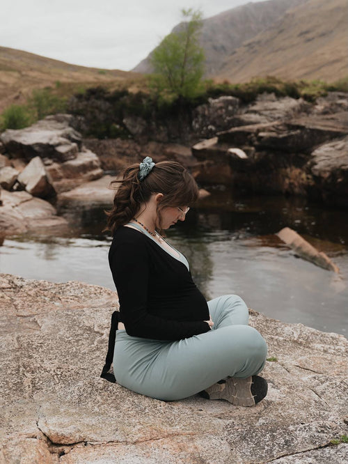 Woman wearing Willoma bamboo activewear by a mountain lake, embracing mindful movement and everyday comfort in premium breathable bamboo fabric.