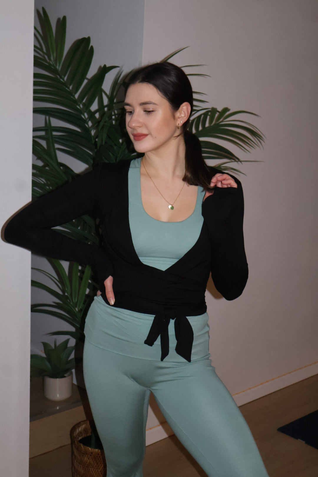 woman wearing black wrap style top